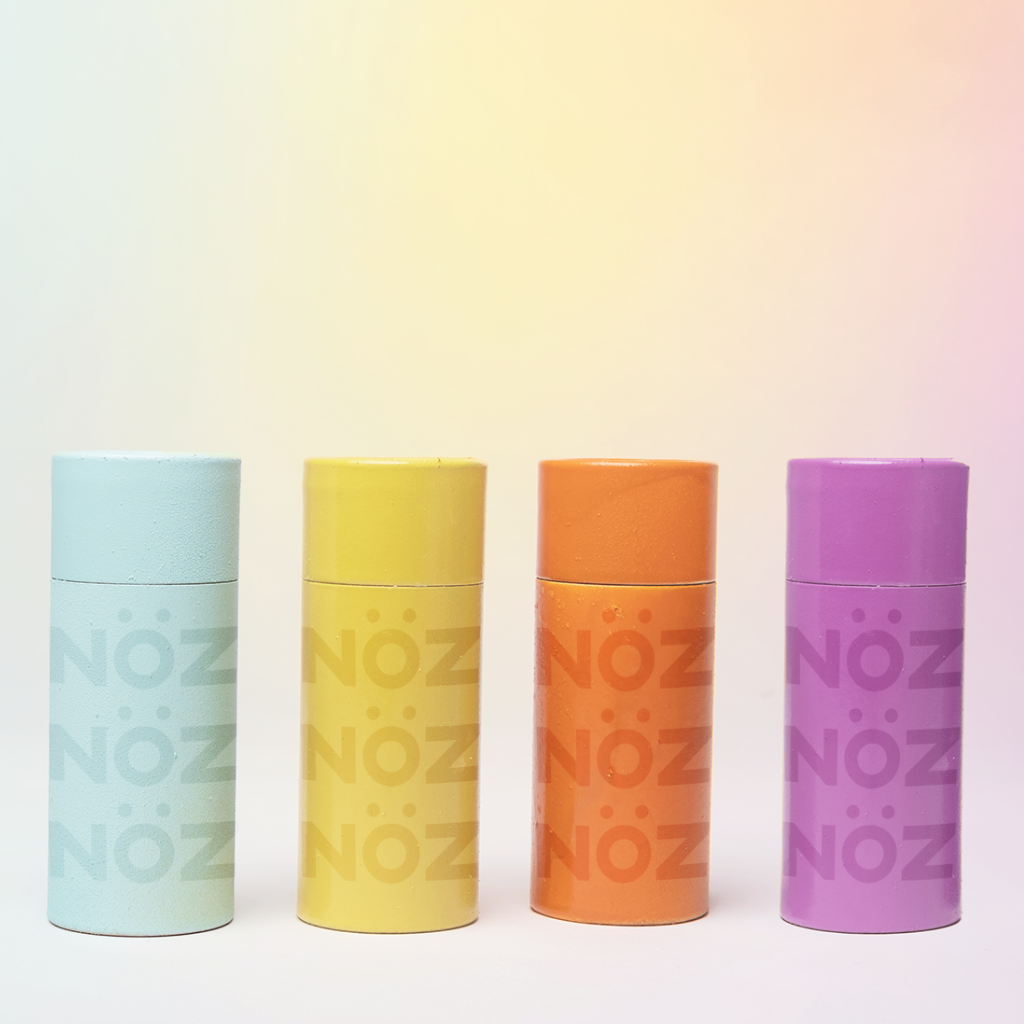 Front view of Nöz sunscreen lineup in blue, yellow, orange, and purple. 